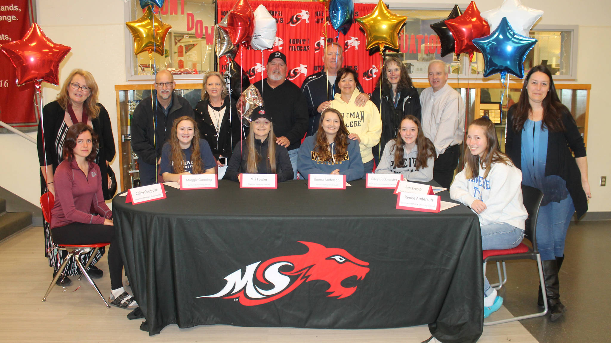 Mount Si High seniors who signed letters of intent to play on college teams next year celebrate with their parents on April 18 in the school commons. Left to right, Chloe Cosgrove (University of Montana/Davidson Honors College, cross country/track), Maggie Gunning (Northwest University, soccer), Mia Fowler (Chapman University, soccer), Emma Anderson (Whitman College, volleyball), Riley Buckmaster (Pacific Lutheran University, track and field) and Renee Anderson (Lawrence Technical University, soccer). Julia Crumb (Pacific University, swimming) is not pictured. Photo courtesy of Mount Si High