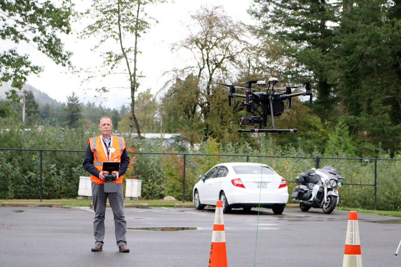 Reserve Firefighter David Geller takes the drone for a short flight around the North Bend Fire Station. Evan Pappas/Staff Photo