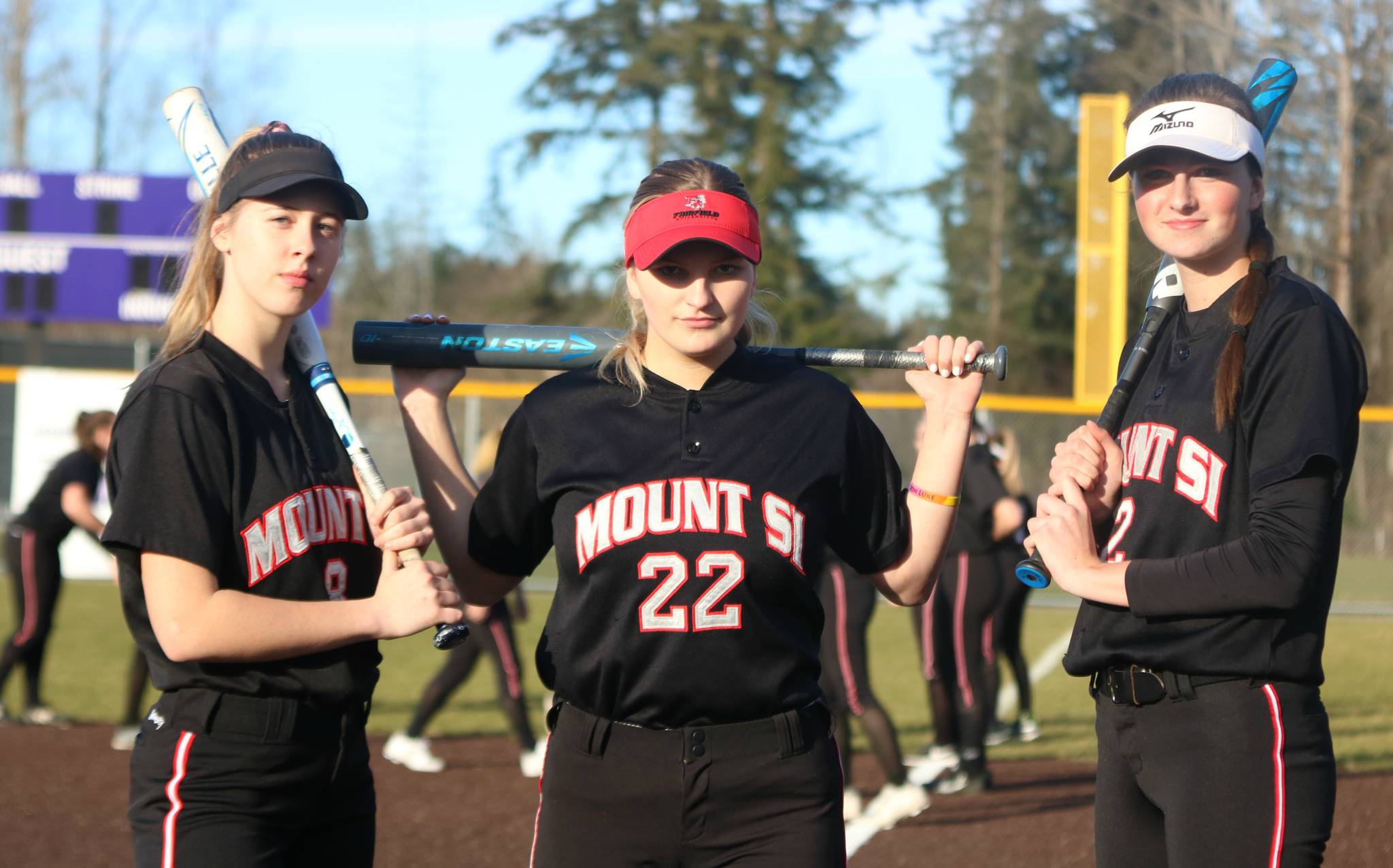 From left, Samantha Simmons, Abby Gronewald and Molly Wilbourne get prepared for a recent game against North Creek. Andy Nystrom / staff photo