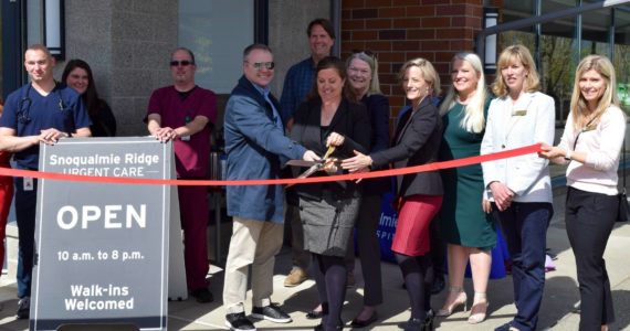 Snoqualmie Valley Hospital CEO Renee Jensen (center) is joined by hospital staff and Snoqualmie elected officials to celebrate the opening of the Snoqualmie Ridge Urgent Care on May 4. Photo Conor Wilson/Valley Record.