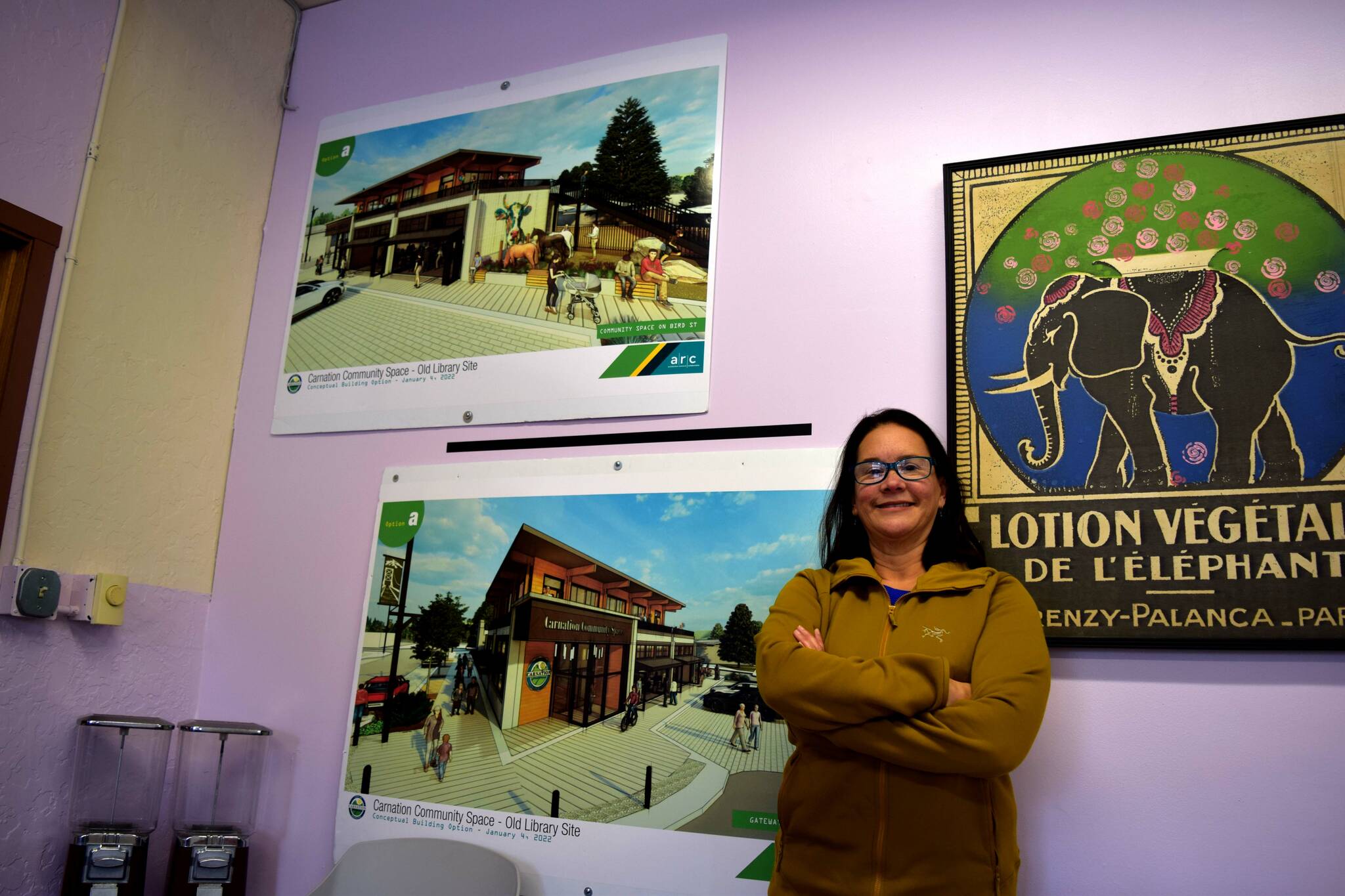 Ana Cortez, Carnation’s city manager, poses in front of designs for the new city hall building being built at the old library site. Photo by Conor Wilson/Valley Record