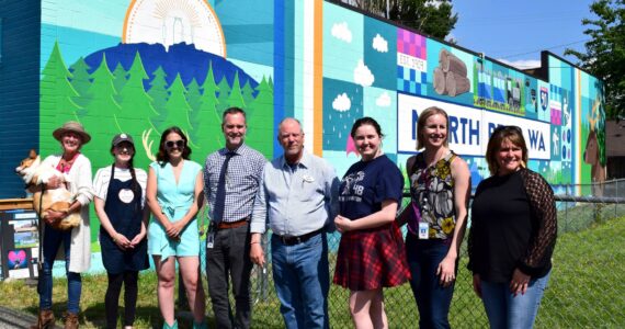 Photos by Conor Wilson/Valley Record
From left: North Bend Councilmember Mary Miller, Pressed on Main owner Hayley Raff, Artist Sarah Hugues, SVSD Superintendent Dan Schlotfeldt, North Bend Mayor Rob McFarland, Two Rivers student Ava Mulligan, Two River Principal Catherine Fredenburg, and Two Rivers Internship Coordinator Chrissy Riley.