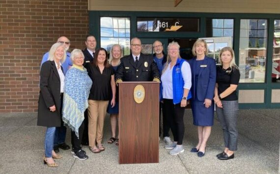 Police Chief Brian Lynch with Snoqualmie and North Bend officials at the June 24 opening of a police substation at North Bend Outlet Mall. (Photo by Mallory Kruml/Valley Record)