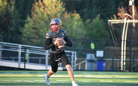 Mount Si quarterback rolls outside the pocket during a simulated drill. Ben Ray / Valley Record