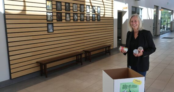 North Bend Mayor Mary Miller dropping off soup cans at the city hall collection bin. Courtesy photo