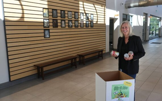 North Bend Mayor Mary Miller dropping off soup cans at the city hall collection bin. Courtesy photo