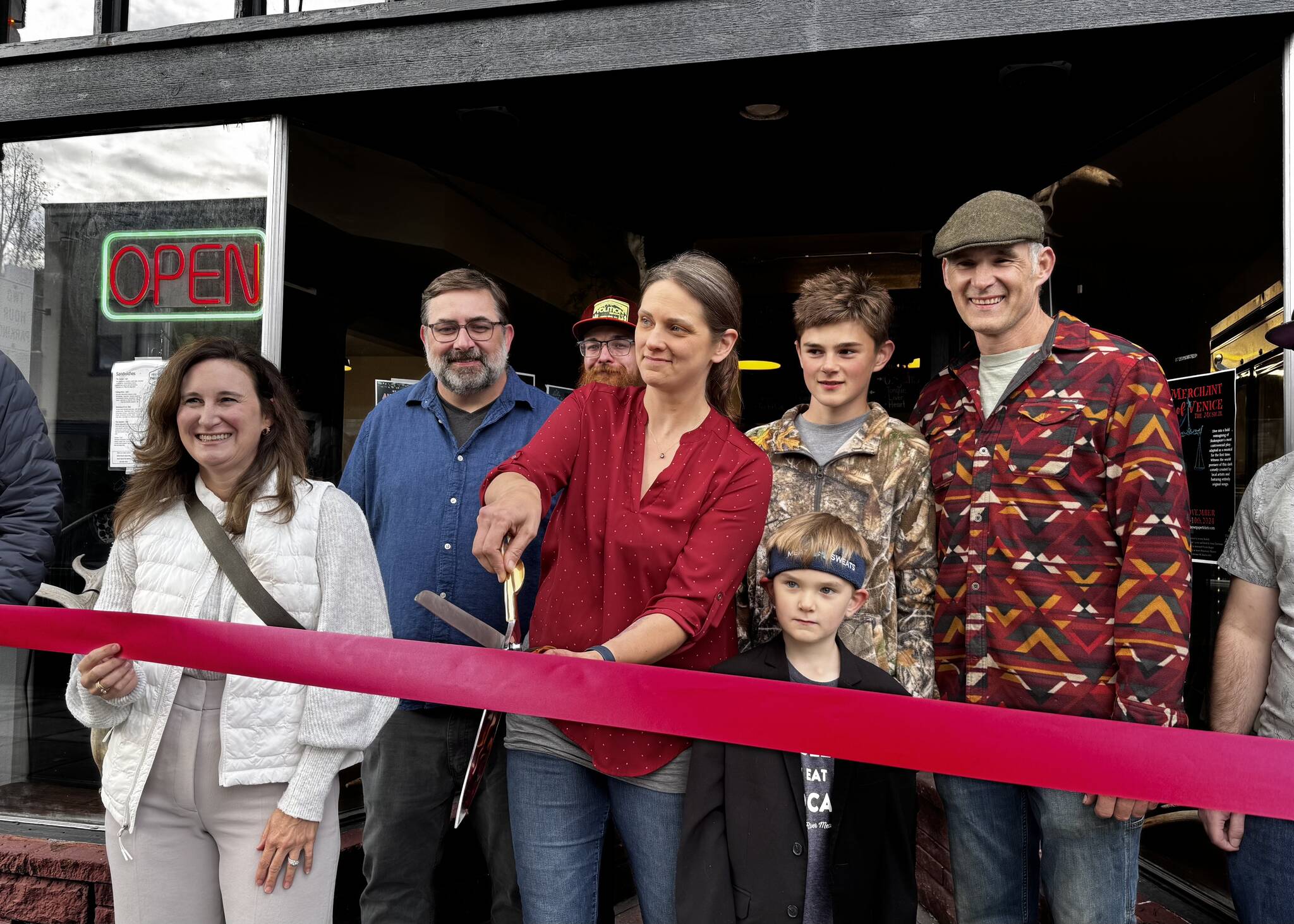 Christeena Marzolf prepares to cut a celebratory ribbon with family and friends at Falling River Meats Oct. 17, 2024. From left: Valerie Pacheco, Snoqualmie Valley Chamber of Commerce board secretary; Justin Fitch, Falling River Meats chef; Christeena Marzolf, Falling River Meats co-owner; Marcus Marzolf; Rowan Marzolf; Darron Marzolf, Falling River Meats co-owner. Photos by Grace Gorenflo/Valley Record