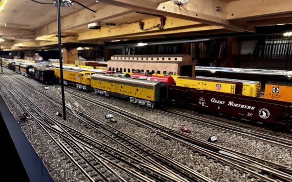 Stationary trains sit on the tracks of the Pacific West Rail display, including models of trains from Great Northern, Union Pacific and Southern Pacific rail companies. (Grace Gorenflo/Valley Record)