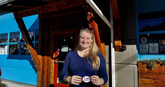 To the Mountain shuttle company owner Meg White stands for a photo outside Pro Ski Service, a partner business and one of the shuttle’s stops in North Bend. (Grace Gorenflo/Valley Record)