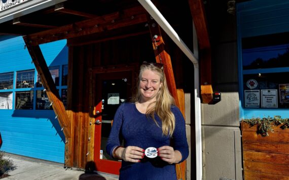 To the Mountain shuttle company owner Meg White stands for a photo outside Pro Ski Service, a partner business and one of the shuttle’s stops in North Bend. (Grace Gorenflo/Valley Record)