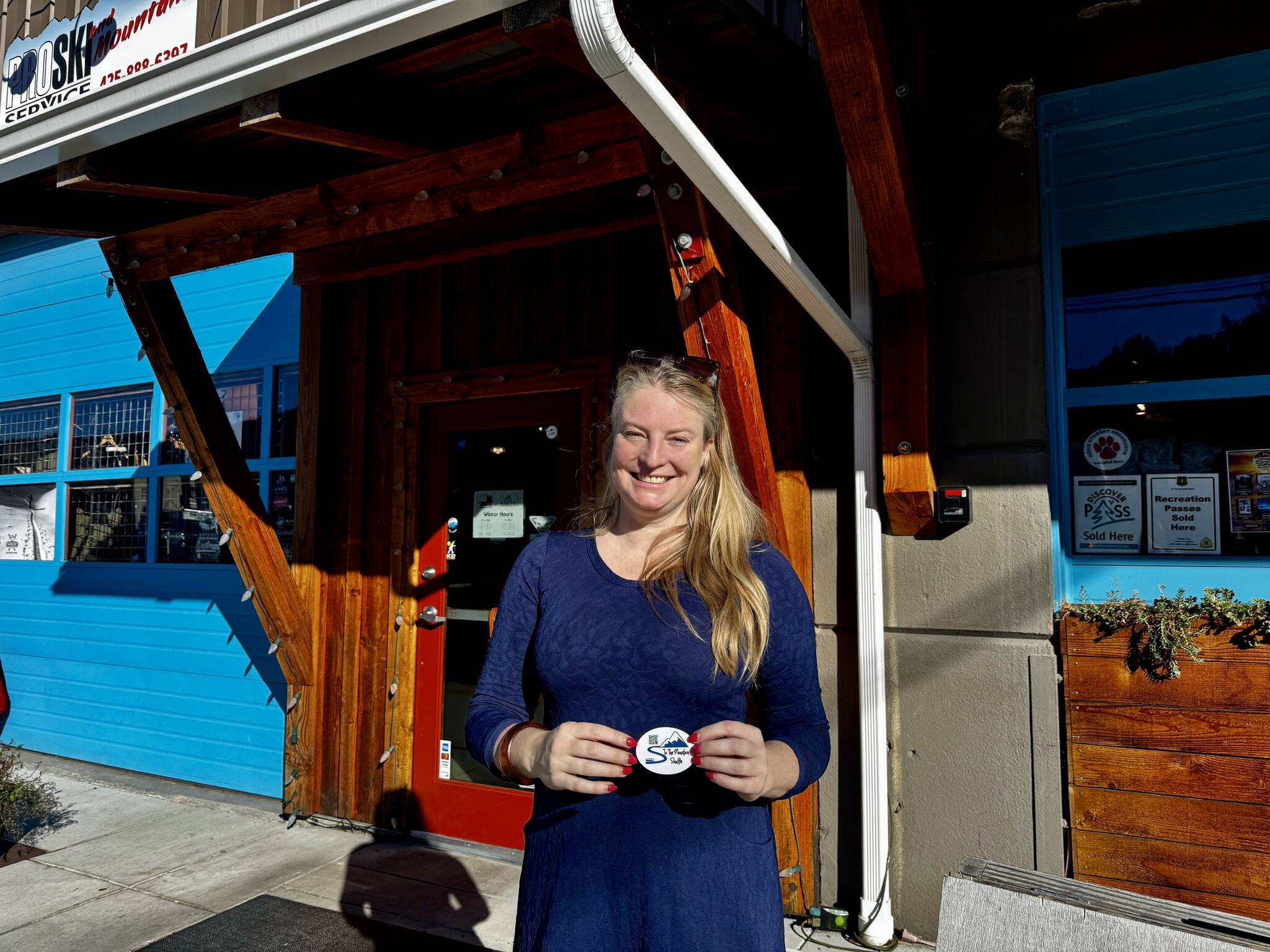 To the Mountain shuttle company owner Meg White stands for a photo outside Pro Ski Service, a partner business and one of the shuttle’s stops in North Bend. (Grace Gorenflo/Valley Record)