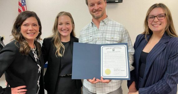 Jordan Perry, holding Carnation’s Jordan Perry Month proclamation, stands for a photo with members of Carnation staff. Courtesy of the city of Carnation