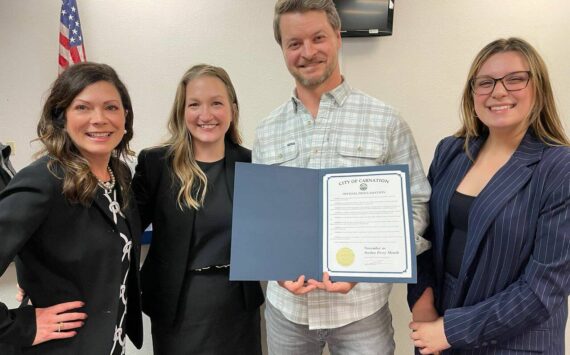 Jordan Perry, holding Carnation’s Jordan Perry Month proclamation, stands for a photo with members of Carnation staff. Courtesy of the city of Carnation