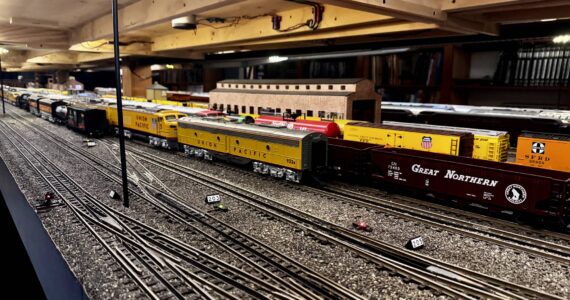 Stationary trains sit on the tracks of the Pacific West Rail display, including models of trains from Great Northern, Union Pacific and Southern Pacific rail companies. (Grace Gorenflo/Valley Record)